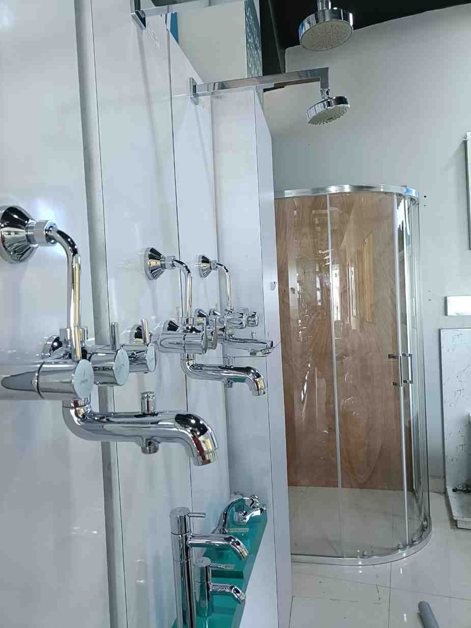 Bathroom fixtures, primarily focusing on faucets and shower systems, likely from a showroom or retail display