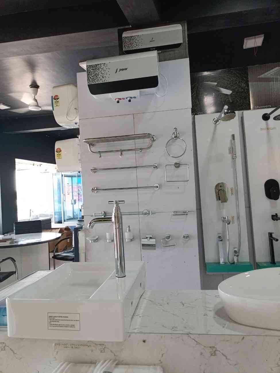 Bathroom hardware and a water heater, likely from a brand like Jaquar, as indicated on the water heater itself