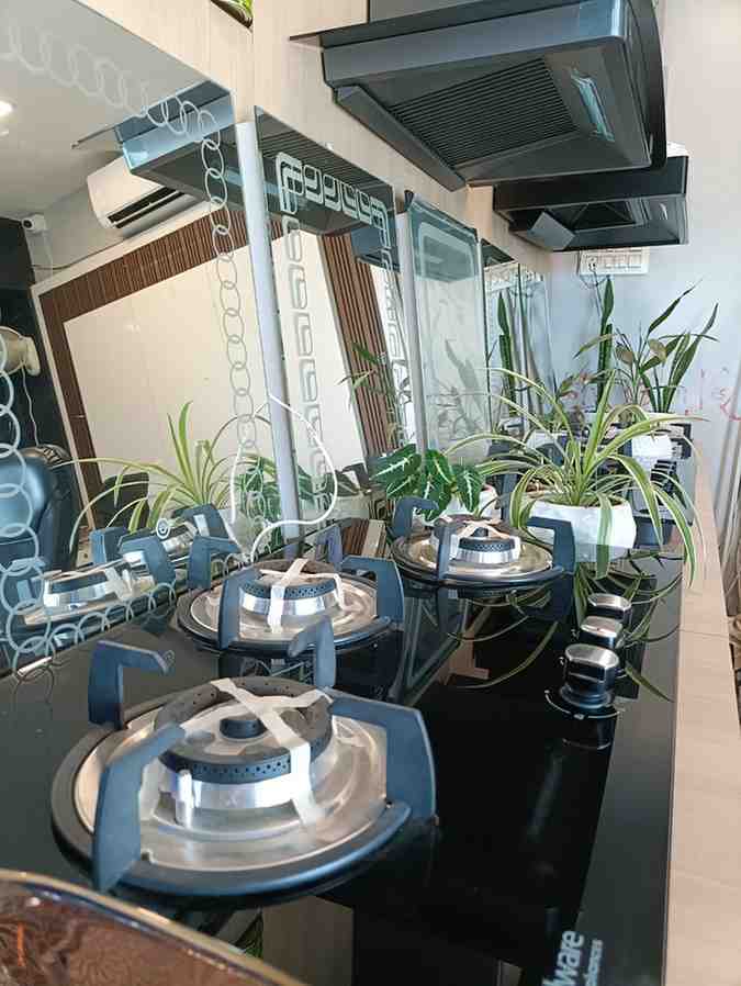 Kitchen appliances, specifically focusing on built-in gas hobs and a kitchen chimney/hood